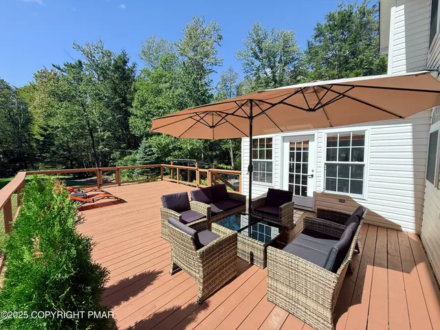 a view of sitting area with furniture and wooden deck