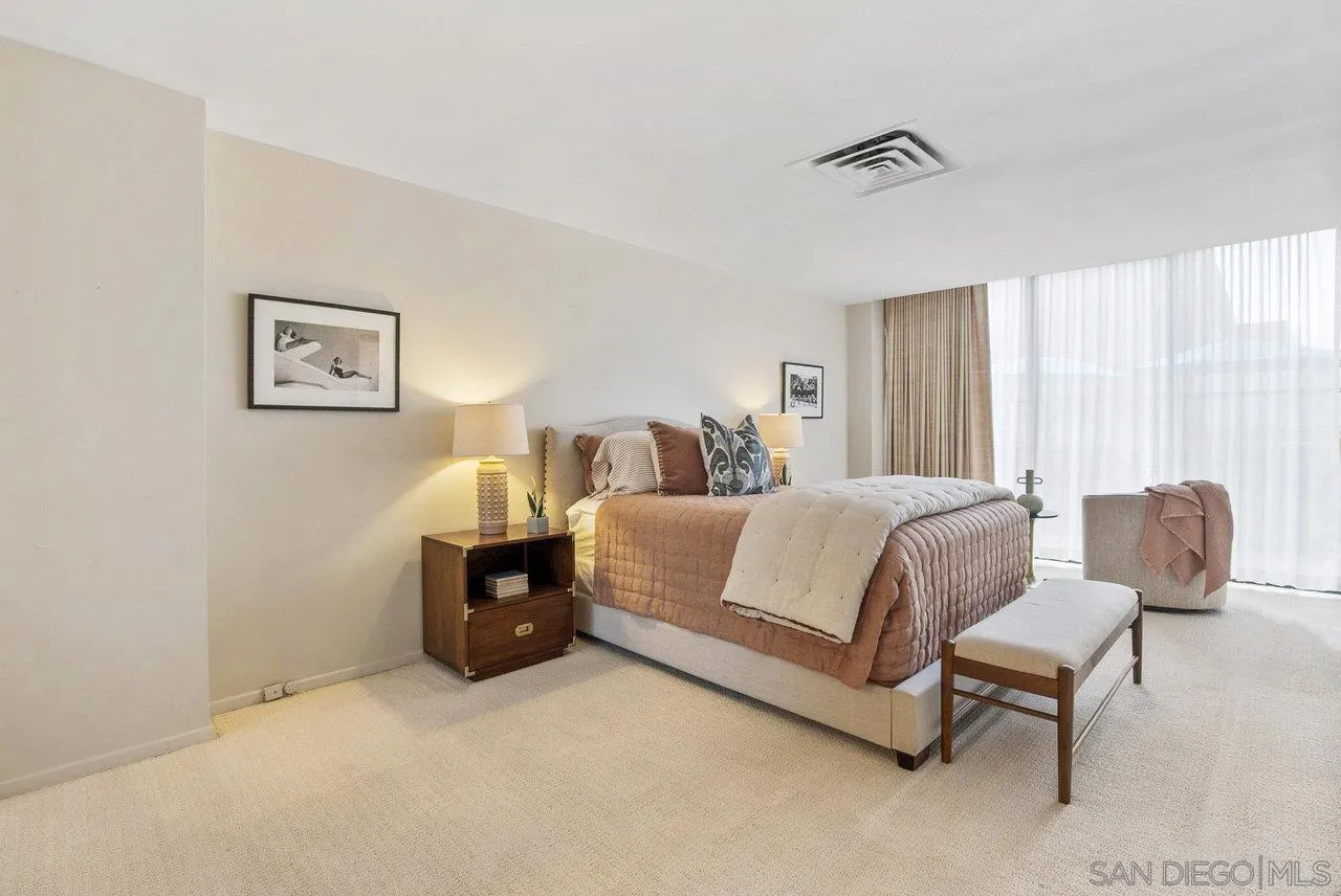 939 Coast Boulevard, Unit 4H La Jolla, CA 92037 - Photo 15 of 39 a bedroom with a bed and a couch