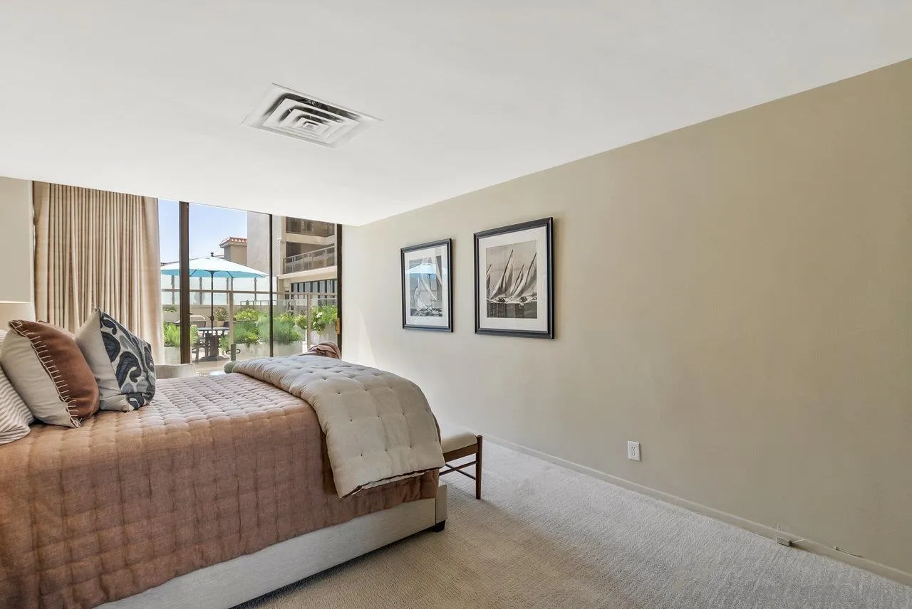 939 Coast Boulevard, Unit 4H La Jolla, CA 92037 - Photo 16 of 39 a bedroom with a bed and a window