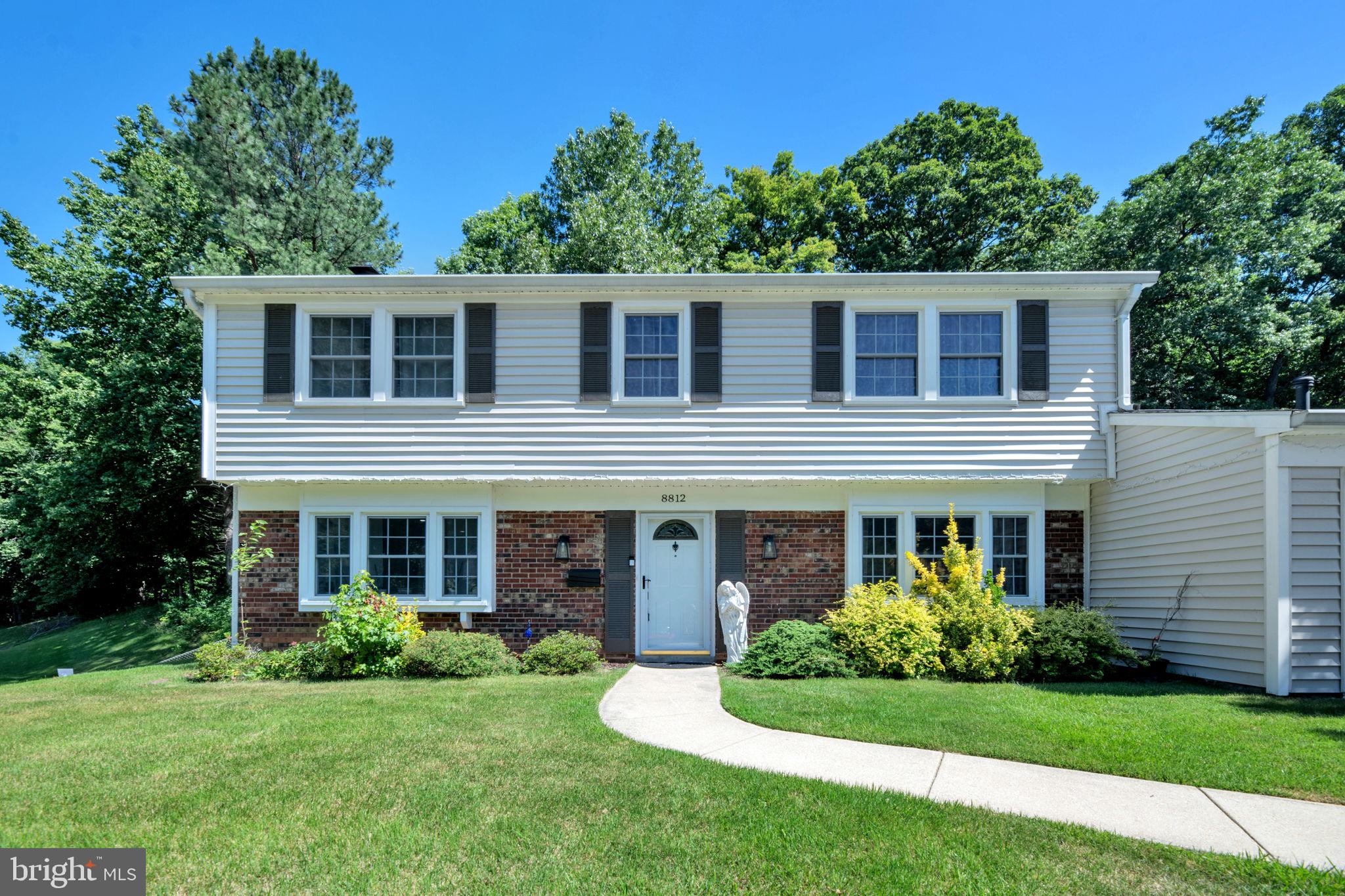 8812 Churchfield Lane Laurel, MD 20708 - Photo 28 of 31 a front view of a house with a yard and trees