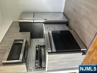 148 Undercliff Avenue, Unit 2 Edgewater, NJ 07020 - Photo 1 of 12 a kitchen with a stove and a microwave