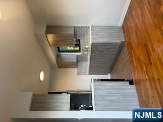 148 Undercliff Avenue, Unit 2 Edgewater, NJ 07020 - Photo 6 of 12 a view of kitchen with cabinets and wooden floor