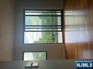 148 Undercliff Avenue, Unit 2 Edgewater, NJ 07020 - Photo 8 of 12 a view of an empty room with wooden floor and a window