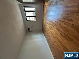 148 Undercliff Avenue, Unit 2 Edgewater, NJ 07020 - Photo 9 of 12 a view of empty room with wooden floor and fan