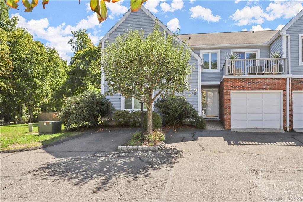 97 West Norwalk Road, Unit 9 Norwalk, CT 06850 - Photo 1 of 1 a front view of a house with a yard and garage