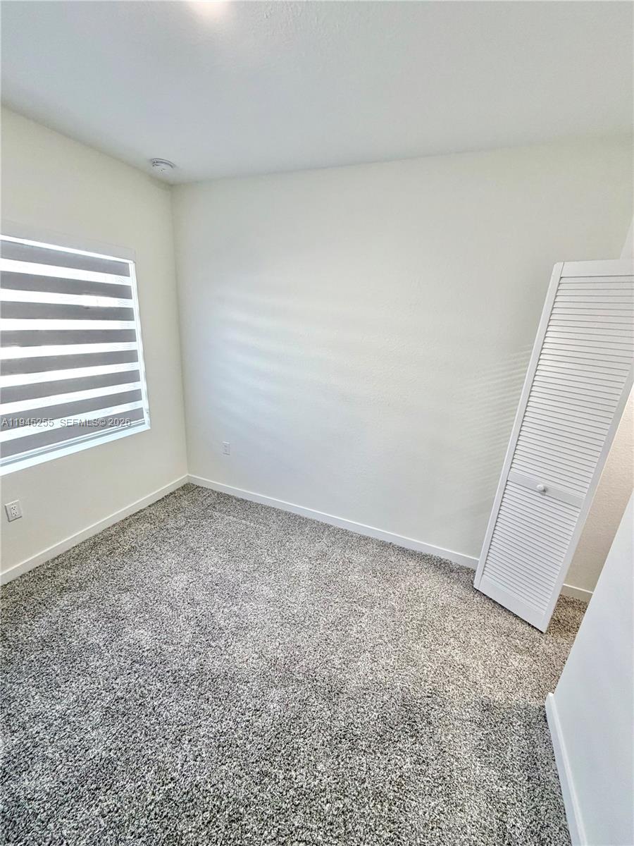 26140 Southwest 146th Court Homestead, FL 33032 - Photo 3 of 7 an empty room with a window