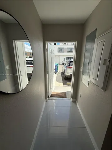 a view of a hallway view with staircase