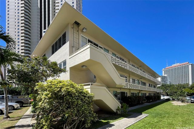 a front view of a building with garden