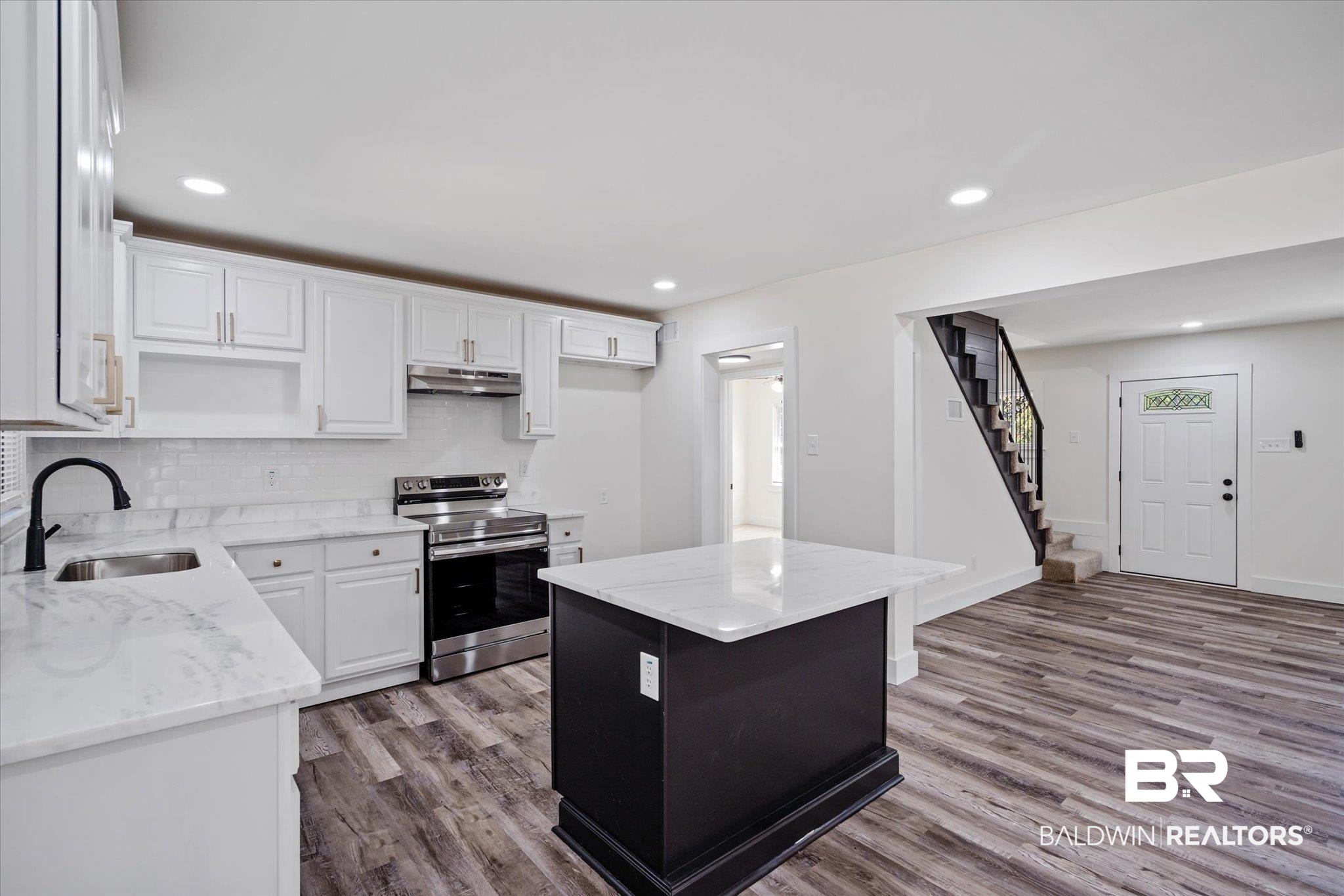 308 Byron Avenue West Mobile, AL 36609 - Photo 7 of 33 Kitchen featuring a kitchen island, light stone counters, electric range, and white cabinetry