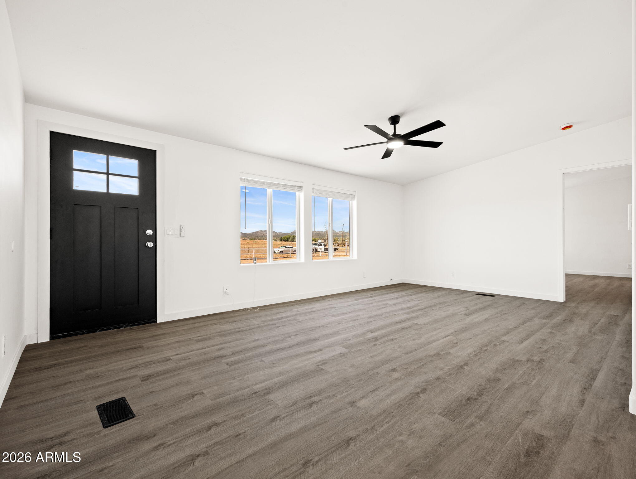 1754 West Deadwood Ranch Road Paulden, AZ 86334 - Photo 9 of 51 wooden floor in an empty room with a window