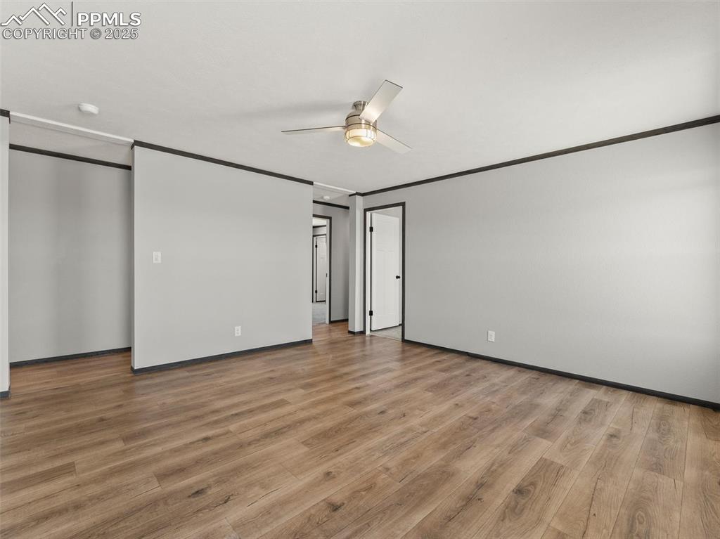 22843 Handle Road Calhan, CO 80808 - Photo 19 of 48 a view of an empty room with wooden floor