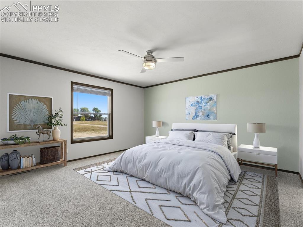 22843 Handle Road Calhan, CO 80808 - Photo 7 of 48 a bedroom with a large bed and a chandelier