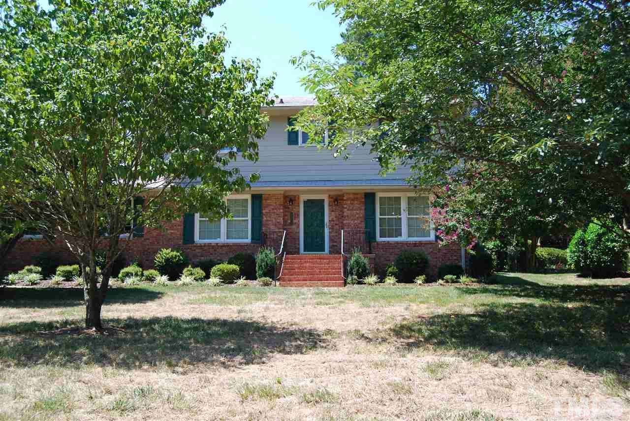 3901 Converse Drive Raleigh, NC 27609 - Photo 2 of 5 a front view of a house with a yard and garage