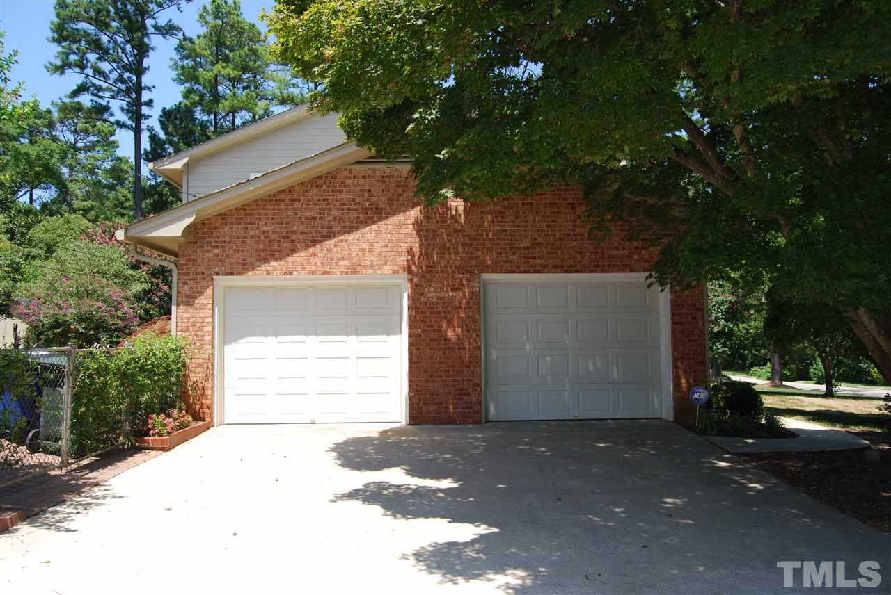 3901 Converse Drive Raleigh, NC 27609 - Photo 3 of 5 a front view of a house with a yard and garage