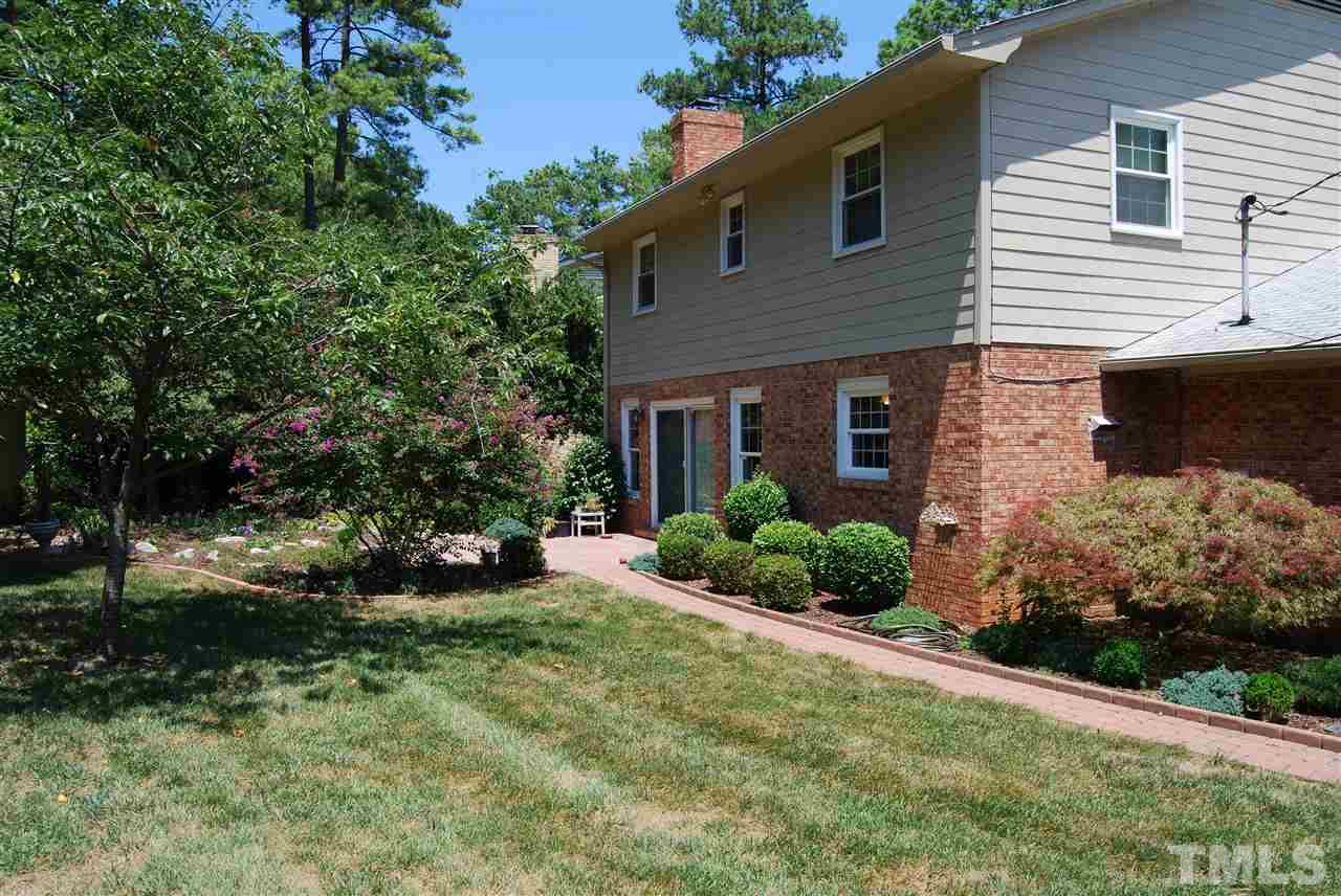 3901 Converse Drive Raleigh, NC 27609 - Photo 4 of 5 a front view of a house with a yard and potted plants