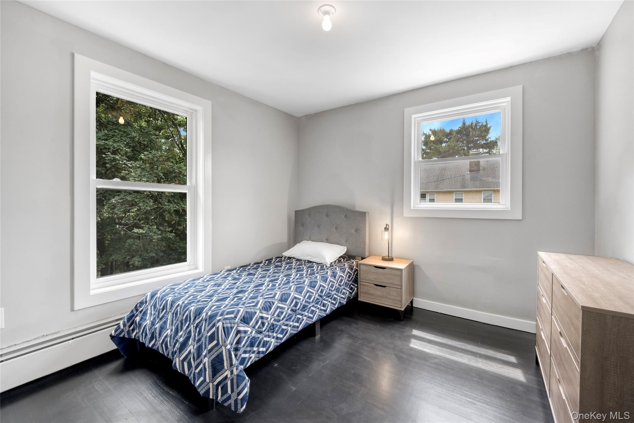 3 Sylvan Place New Rochelle, NY 10801 - Photo 16 of 29 a bedroom with a bed and a window with chair