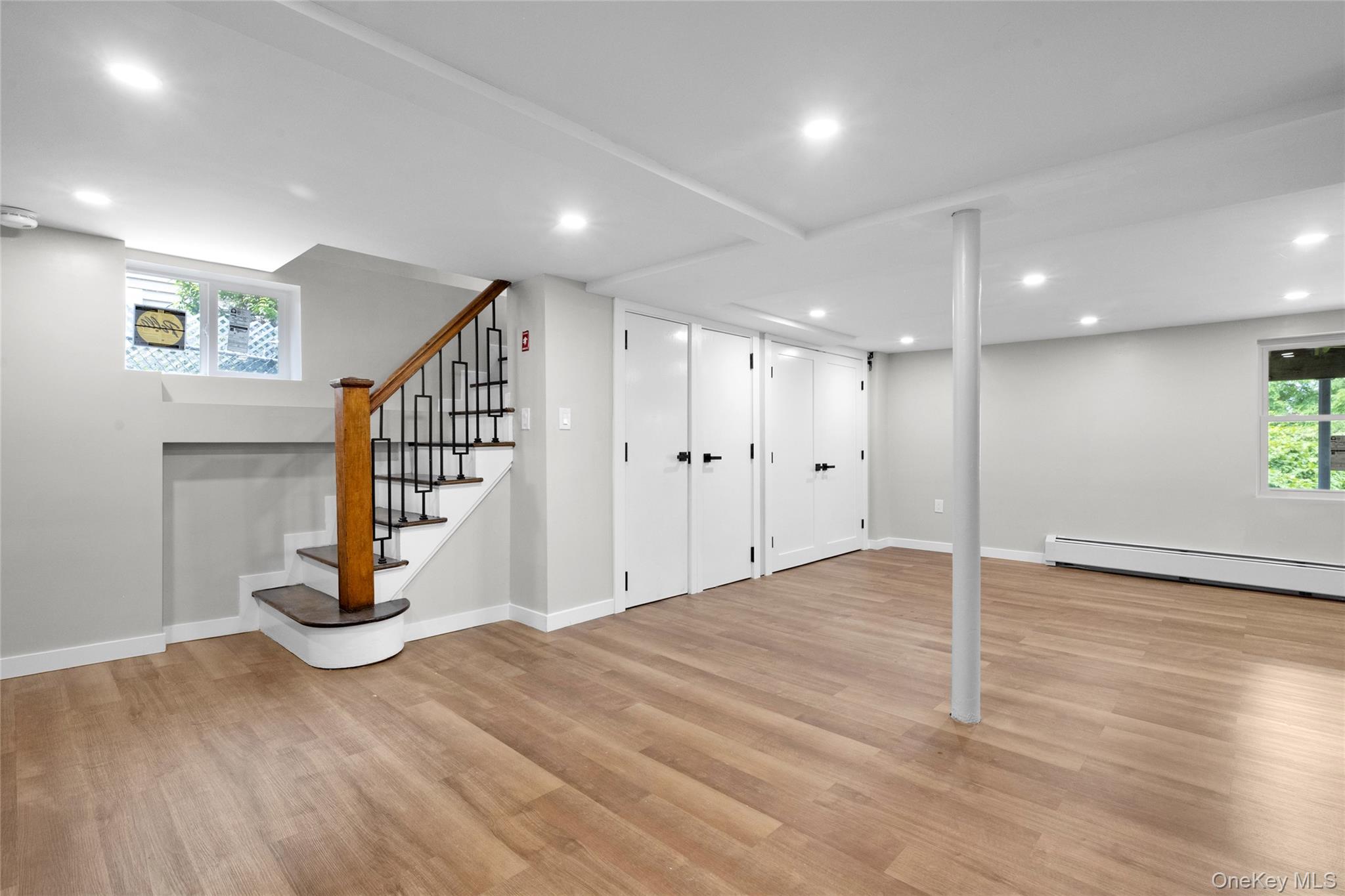 3 Sylvan Place New Rochelle, NY 10801 - Photo 19 of 29 a view of an empty room with stairs and a wooden floor
