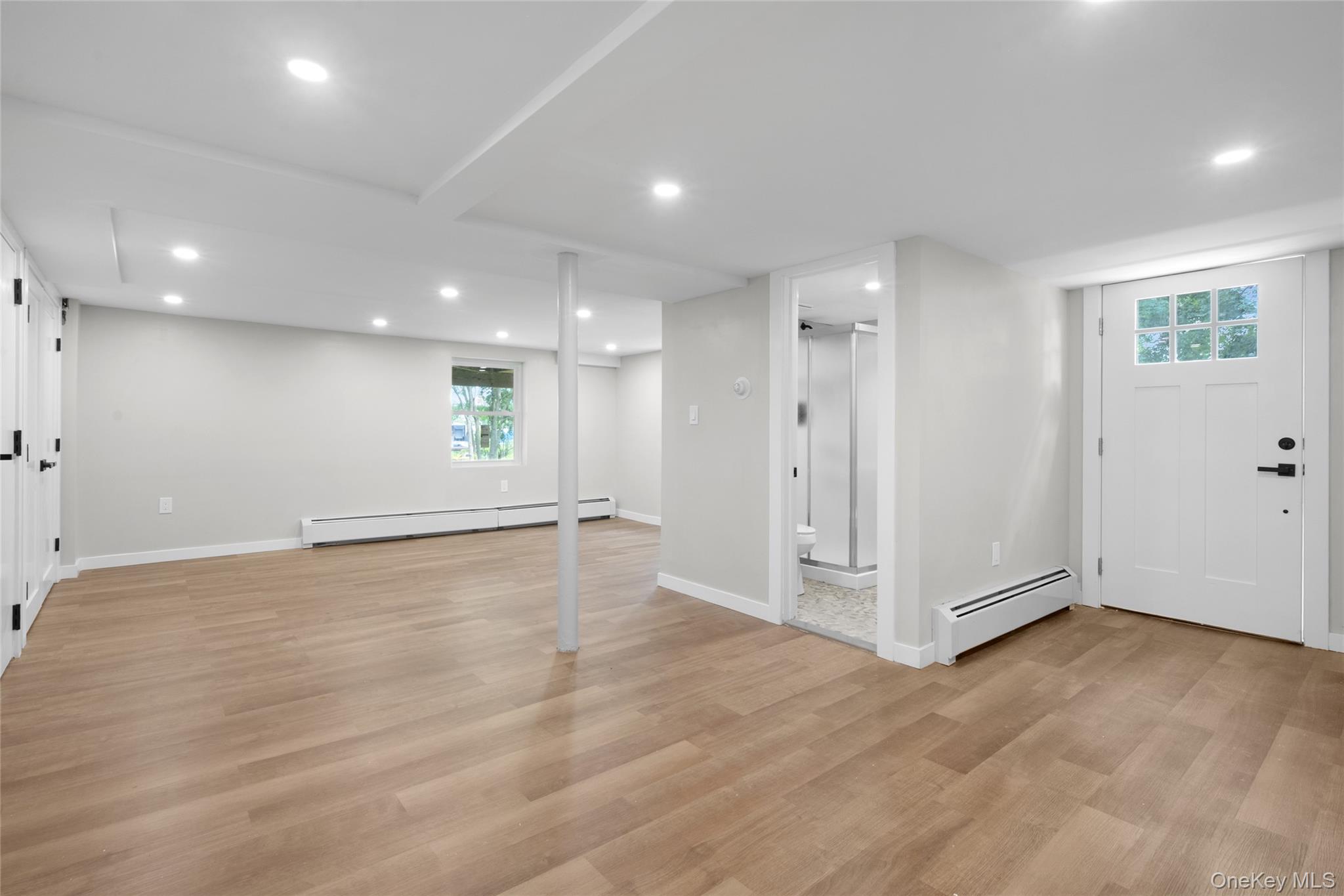 3 Sylvan Place New Rochelle, NY 10801 - Photo 21 of 29 an empty room with wooden floor and white walls