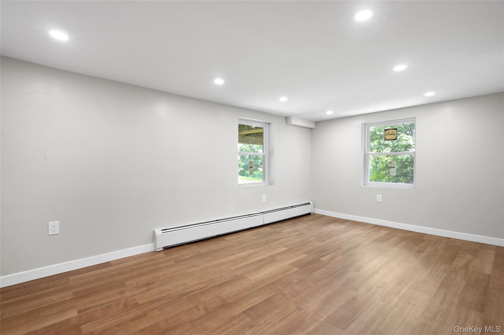 3 Sylvan Place New Rochelle, NY 10801 - Photo 22 of 29 an empty room with wooden floor and windows