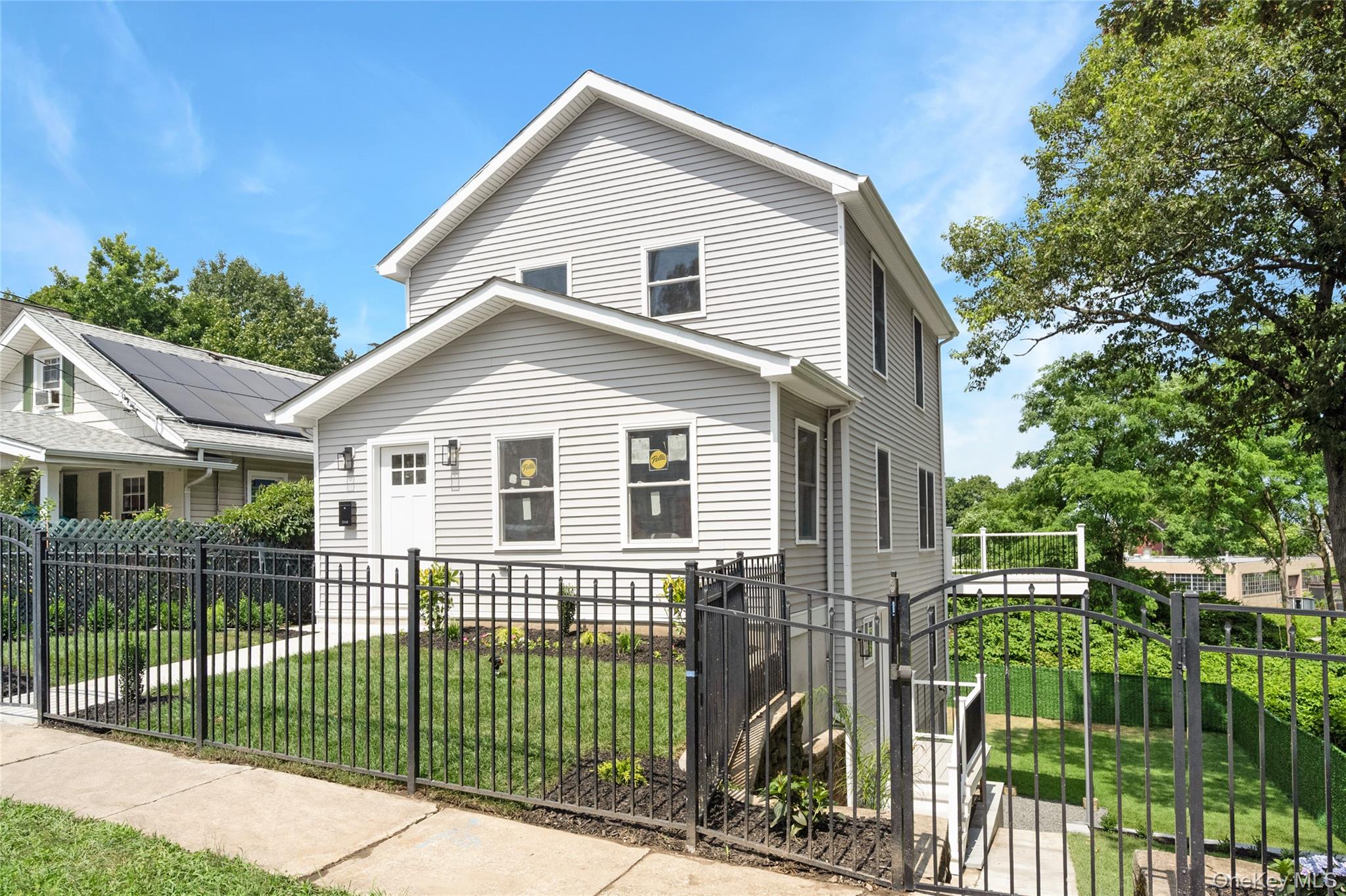 3 Sylvan Place New Rochelle, NY 10801 - Photo 29 of 29 a view of a white house in front of a yard with plants and large trees