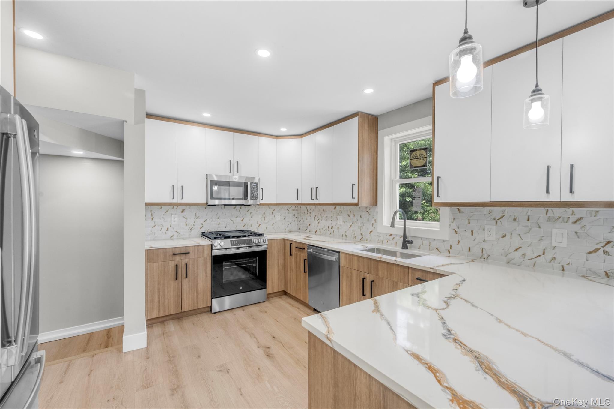 3 Sylvan Place New Rochelle, NY 10801 - Photo 7 of 29 a kitchen with a sink stove and refrigerator