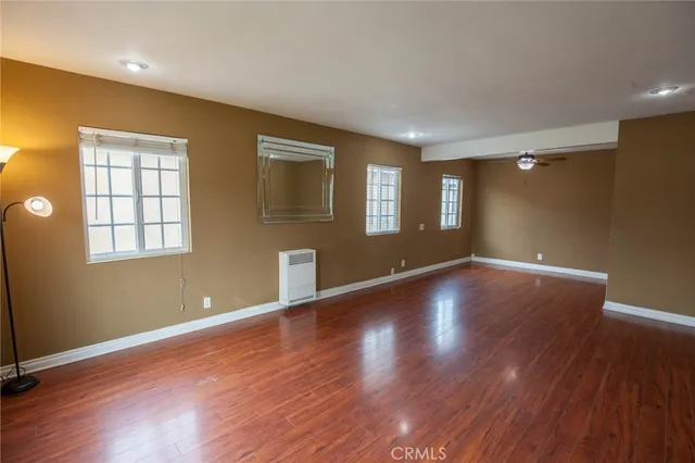 a view of room with window and wooden floor