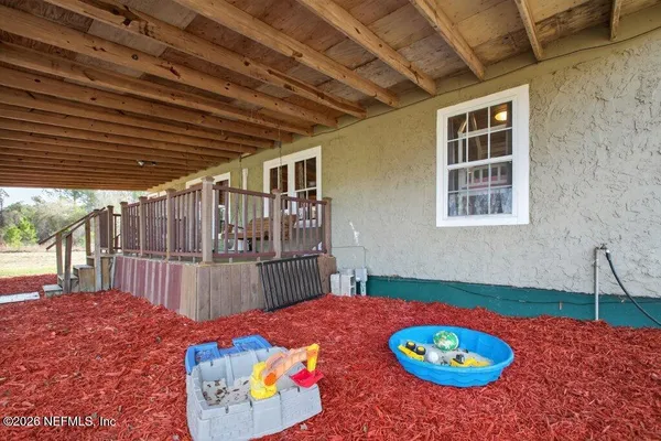 a dining room with furniture and a kitchen view
