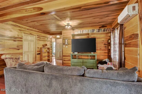 a kitchen with stainless steel appliances granite countertop a refrigerator a sink and white cabinets