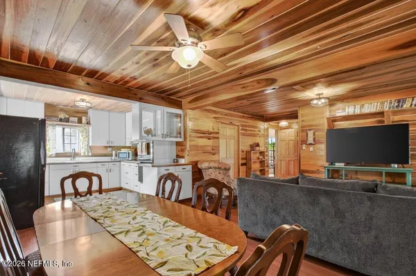 a kitchen with a refrigerator window and cabinets