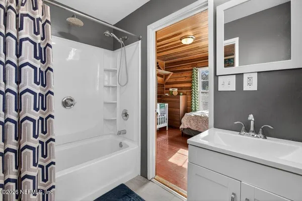 a bed sitting in a room next to a large window