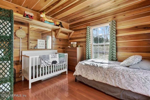 a bed sitting in a bedroom next to a window