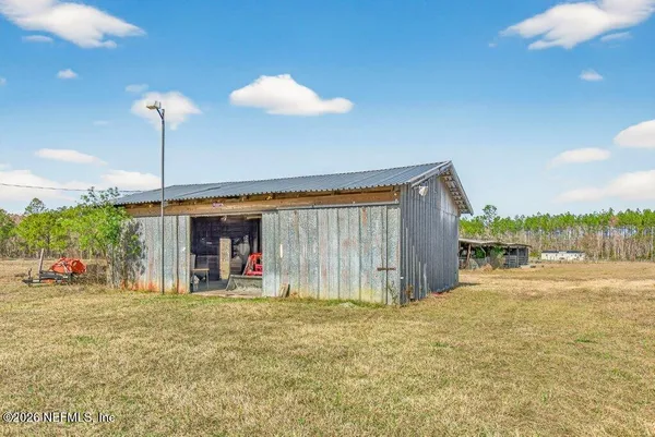 a backyard view with a garden and entertaining space