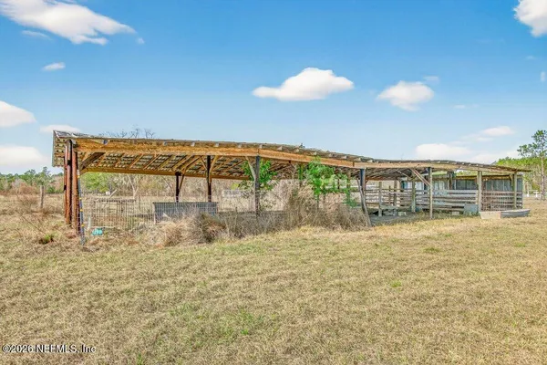 an aerial view of a house with a garden and lake view