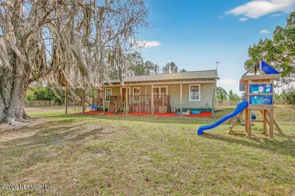 a spacious bedroom with a bed and wooden floor