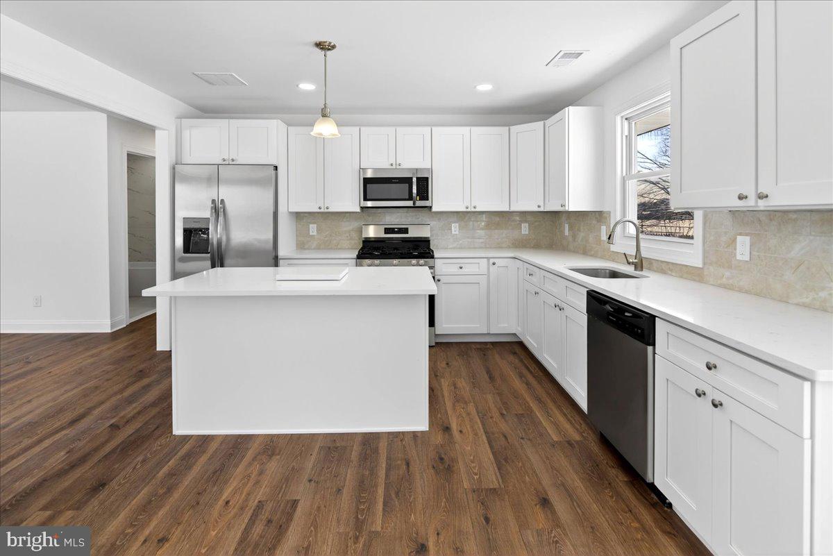 464 Sykesville Road Wrightstown, NJ 08562 - Photo 9 of 32 a kitchen with white cabinets stainless steel appliances and sink