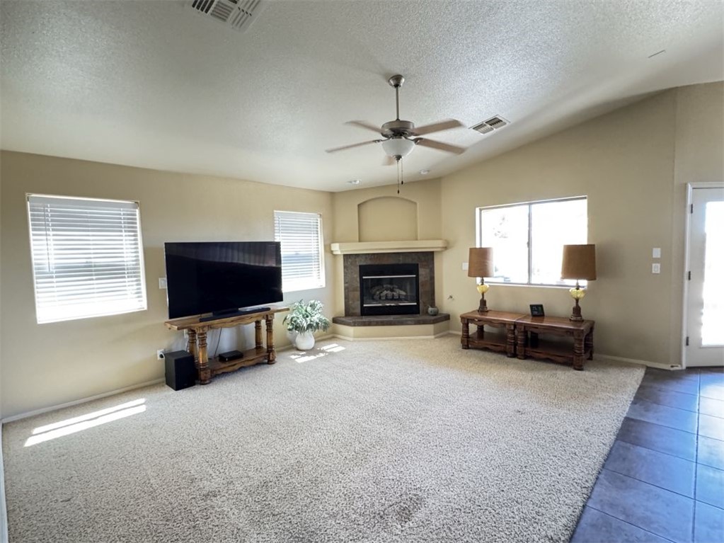 3316 Producers Mine Road Kingman, AZ 86401 - Photo 15 of 35 Living area featuring a corner gas burning fireplace.