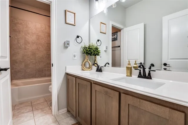 a bathroom with a tub sink and mirror