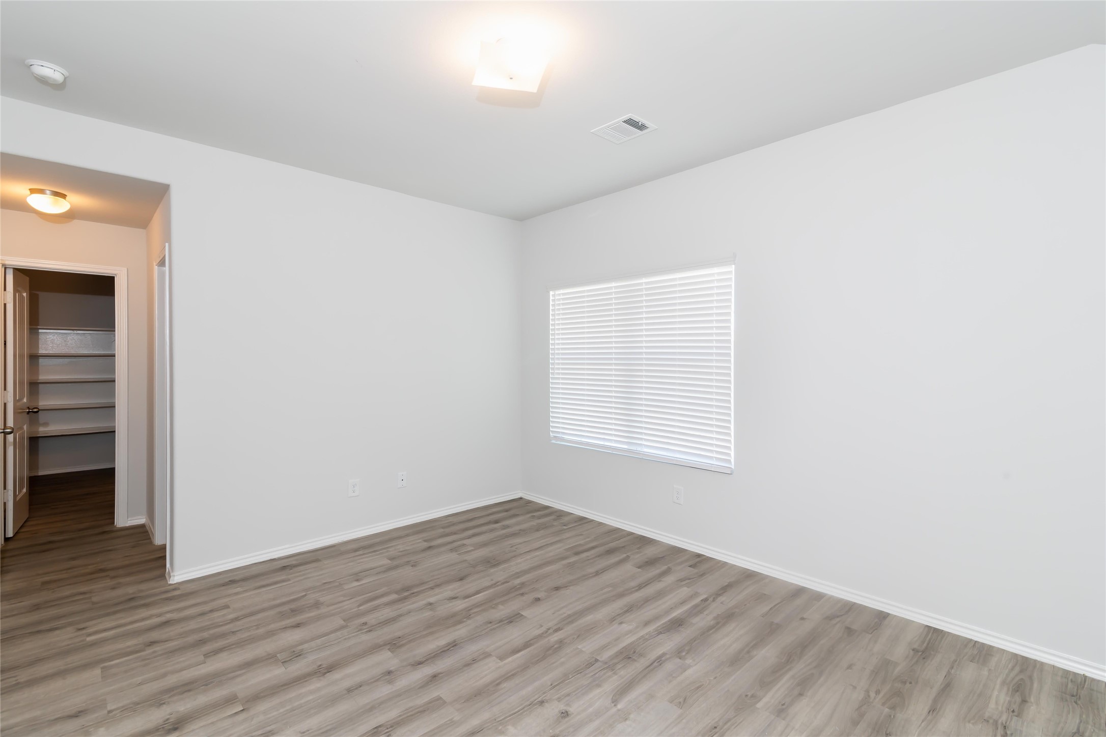 18635 Bell Ravine Drive Katy, TX 77449 - Photo 4 of 12 an empty room with wooden floor and window