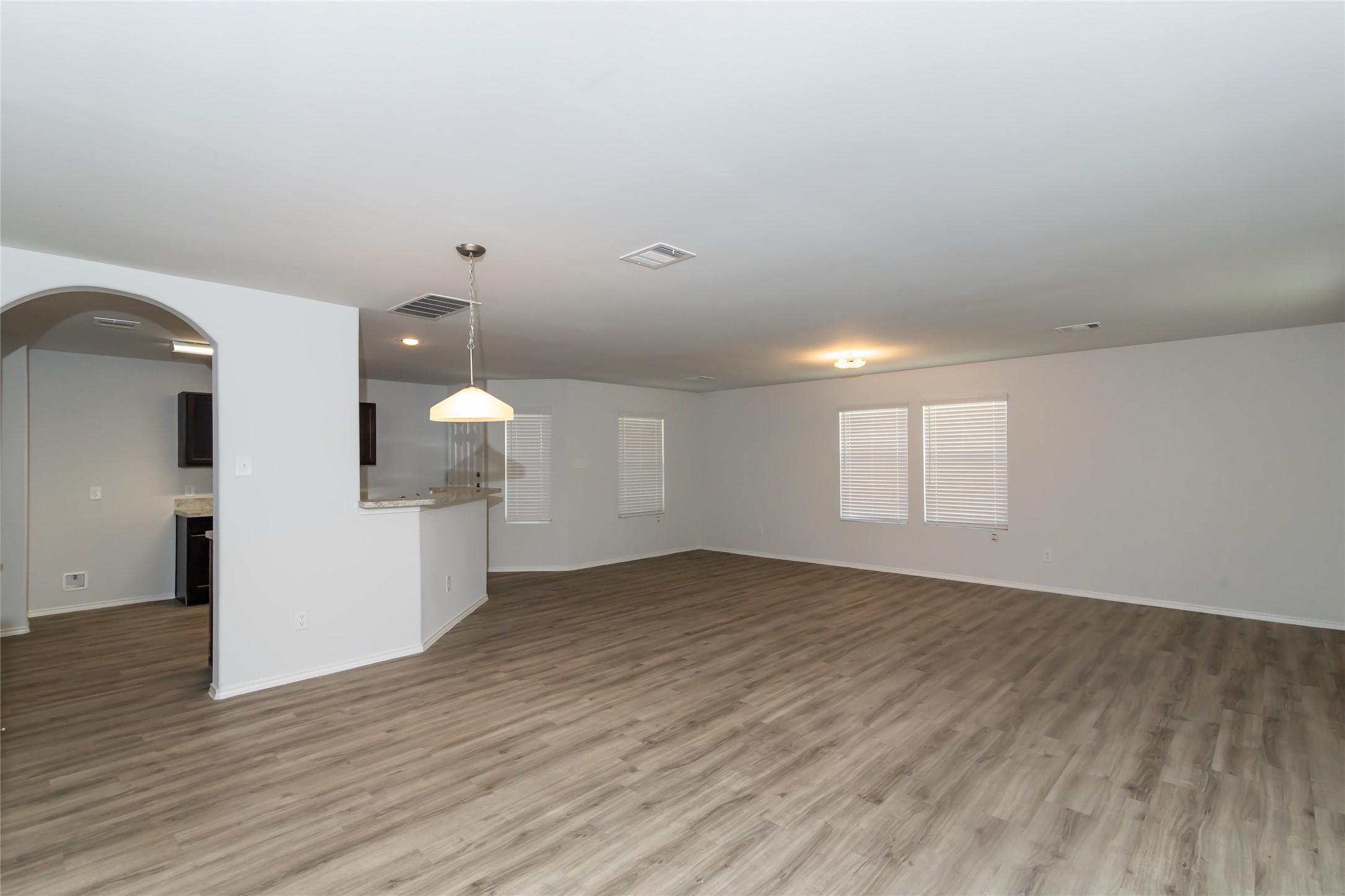 18635 Bell Ravine Drive Katy, TX 77449 - Photo 5 of 12 a view of a room with wooden floor and white walls