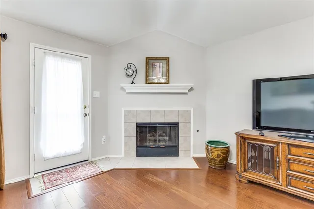 a living room with furniture fireplace and flat screen tv
