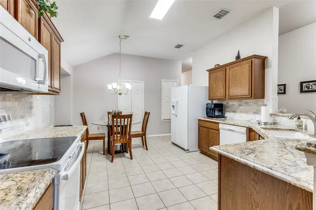 a kitchen with a stove a sink and a refrigerator
