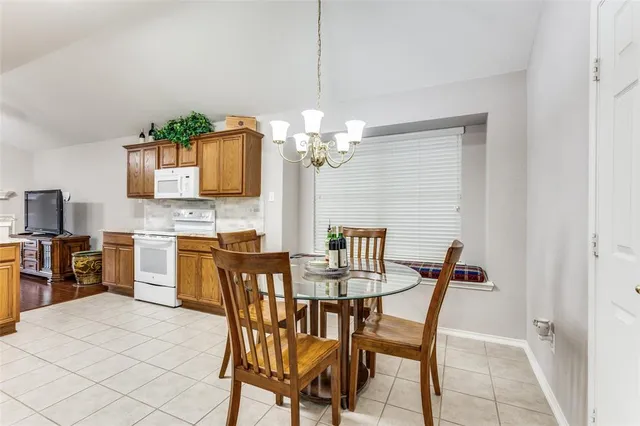 a dining room with furniture and chandelier