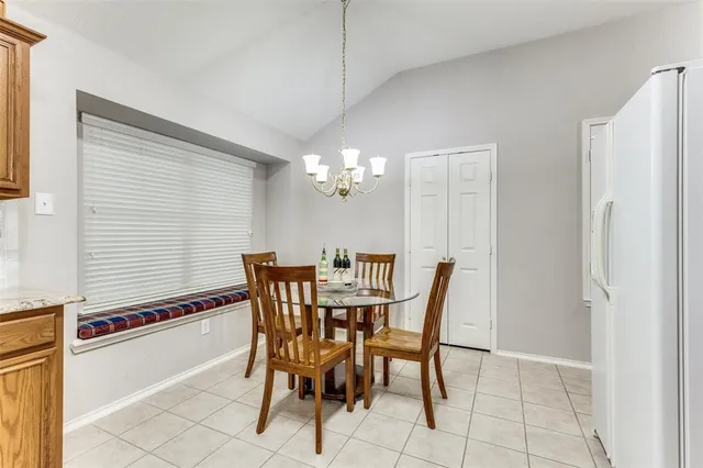 a view of a dining room with furniture and chandelier