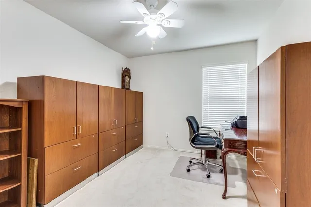 a view of a workspace with furniture and a window