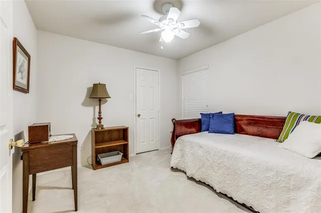 a bedroom with a bed and a lamp on table