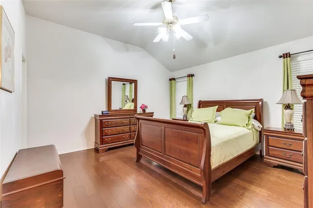 a bed room with a bed and a chair