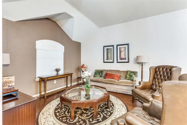 a living room with furniture and a lamp