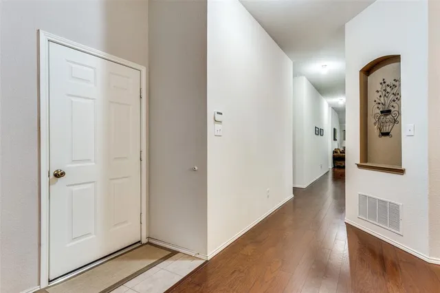 a view of a hallway with wooden floor