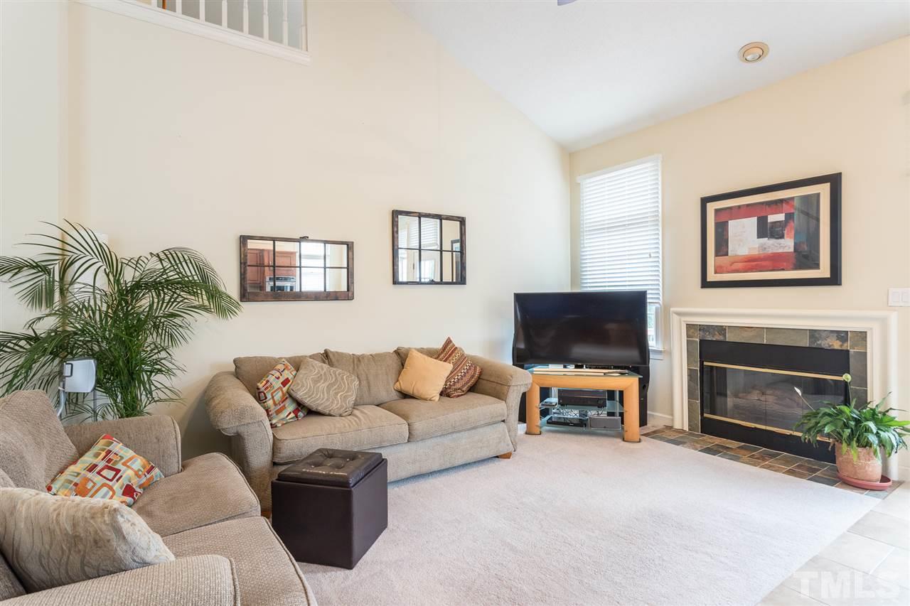10121 Goodview Court Raleigh, NC 27613 - Photo 14 of 30 a living room with furniture and a fireplace