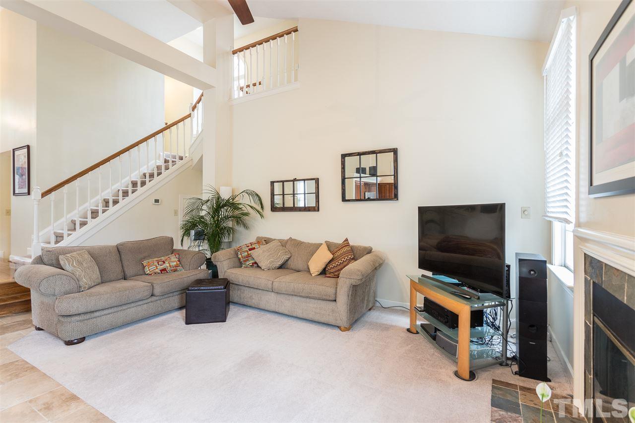 10121 Goodview Court Raleigh, NC 27613 - Photo 15 of 30 a living room with furniture and a flat screen tv
